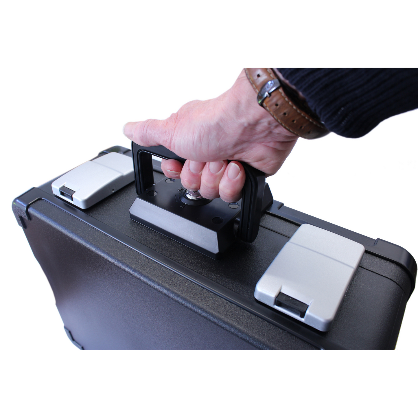 Close-up of a person's picking up a Cathedral Products DSBA4 UL Certified lockable A4 fire and waterproof security chest by the handle. The image captures the moment of lifting the chest, emphasizing the portability of the secure storage solution.