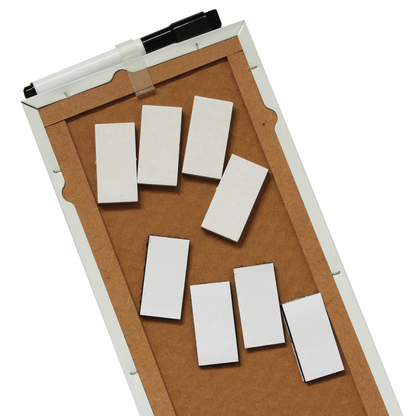 Rear of a frameless dry-erase board showing sturdy MDF backing, as well as reinforced edges, including white sticky pads scattered on the surface and a marker with an eraser attached to the top. The image shows the easy mounting ability of the boards.
