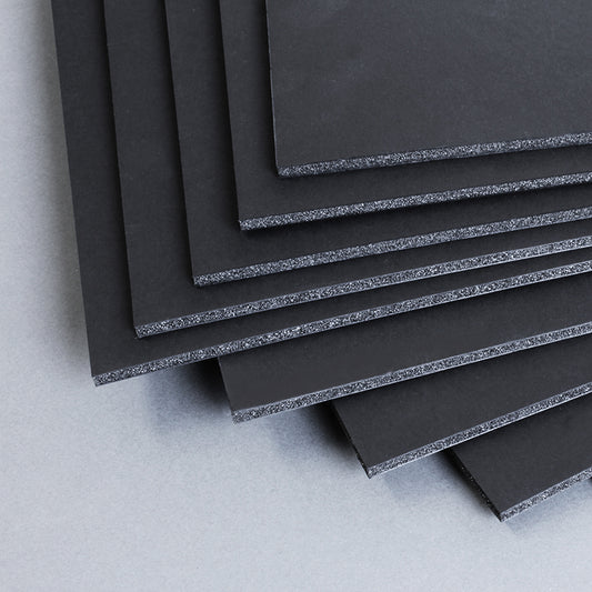 Stack of black 5mm thick A4 size foam boards, measuring 210 x 297mm, neatly arranged in a pack of 20 on a grey background, highlighting the layered foam core structure.