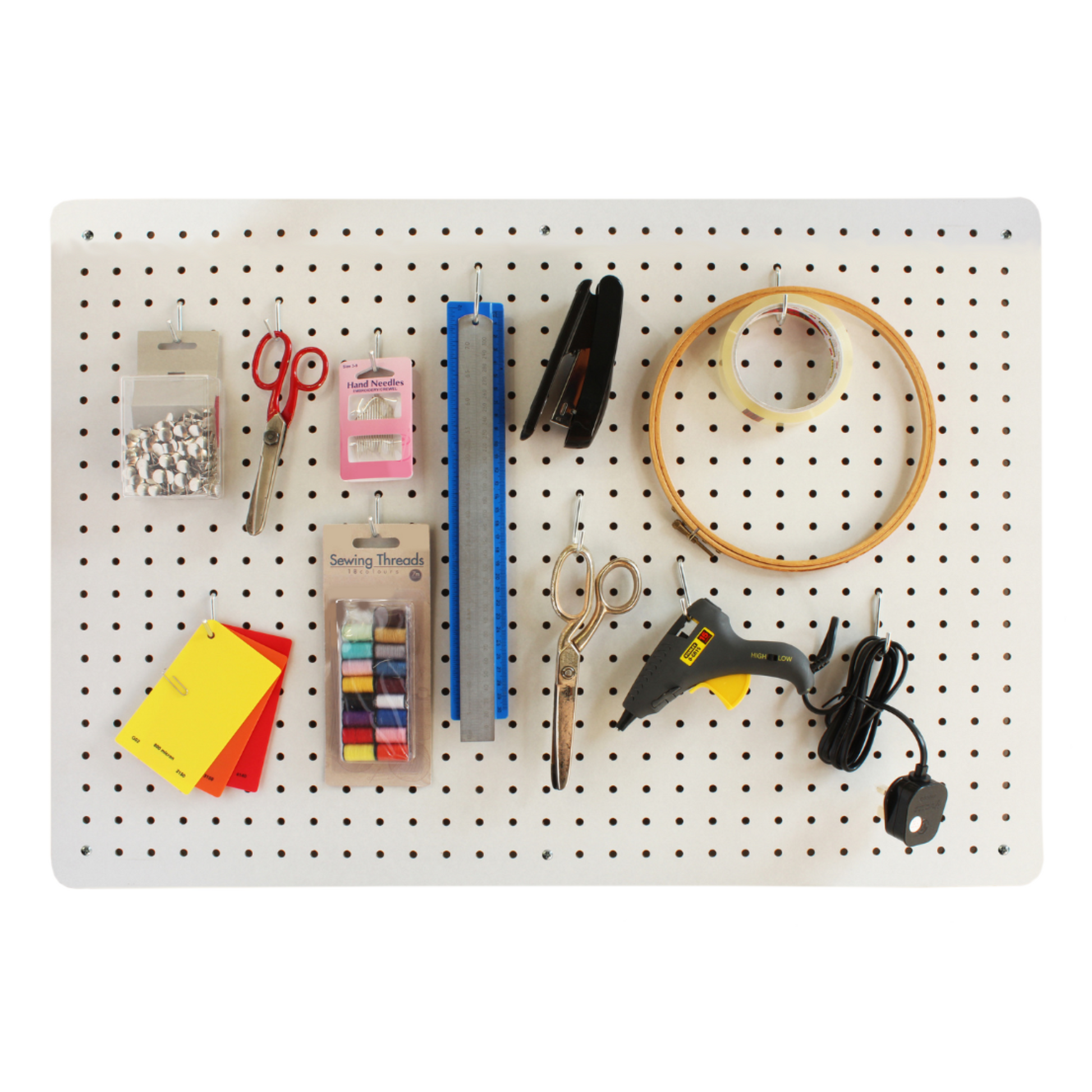 A 76x56cm white pegboard neatly organizing a variety of craft supplies including scissors, sewing threads, hand needles, a ruler, stapler, embroidery hoop and glue gun, illustrating an efficient use of space for creative tools.