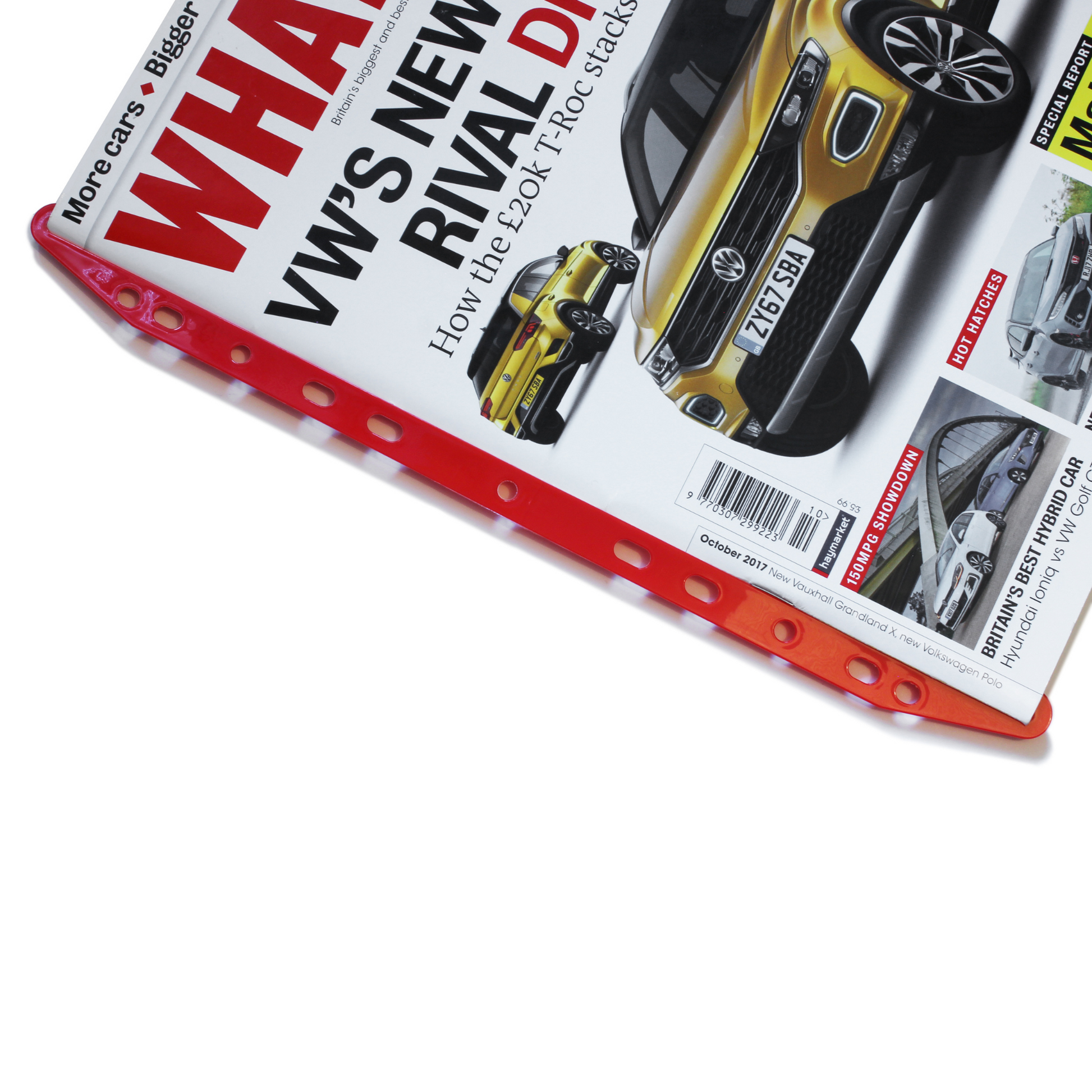 A close-up of a red Magi Clip multi-punched magazine storage clip holding an issue of 'WHAT CAR?' magazine, showcasing a yellow sports car on the cover.
