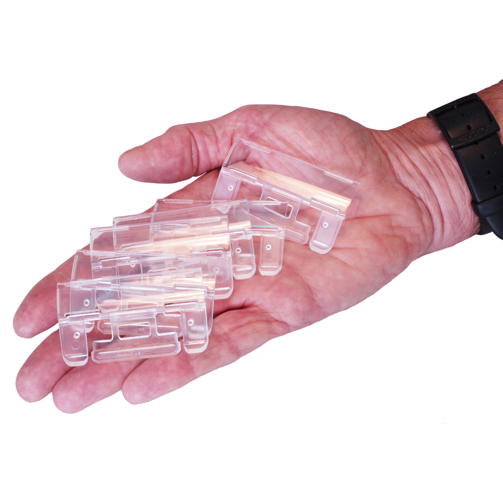 An open human hand displaying several clear plastic filing tabs, part of an office organization system for filing documents.