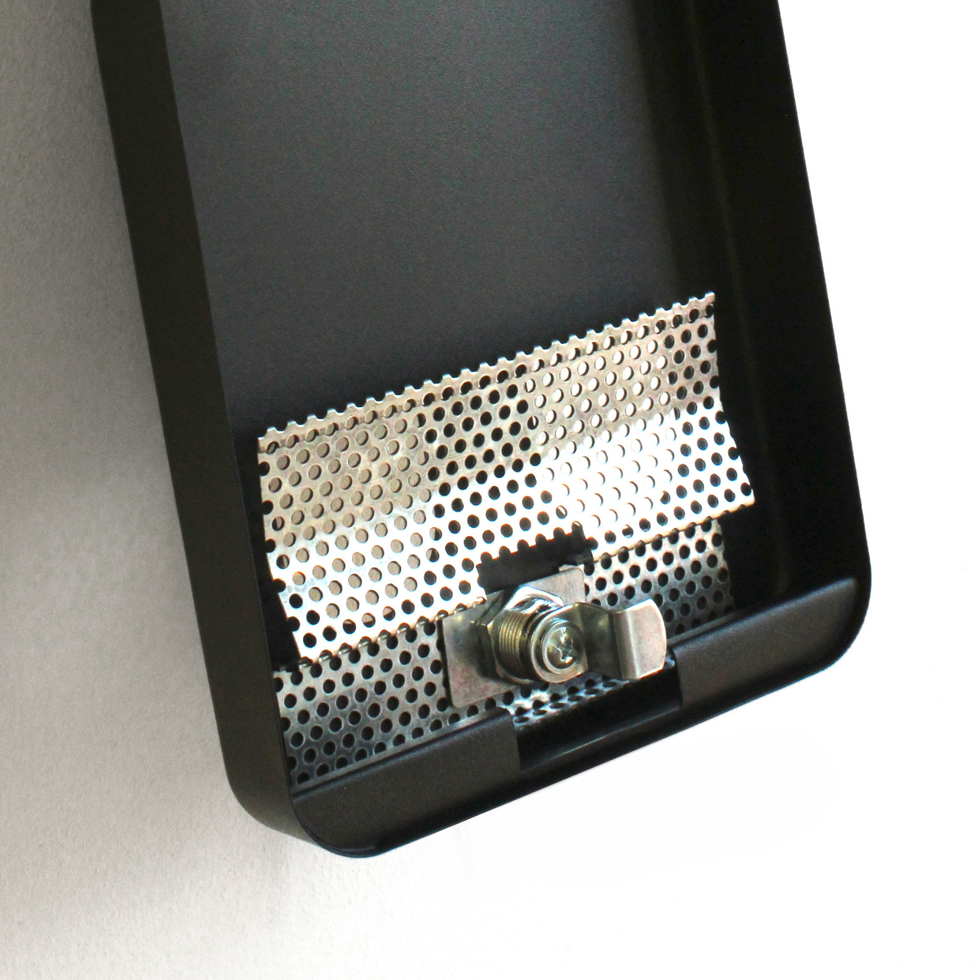 Close-up view of the perforated metal extinguishing plate inside an open wall-mounted ash bin, showing the secure locking mechanism for safe disposal.