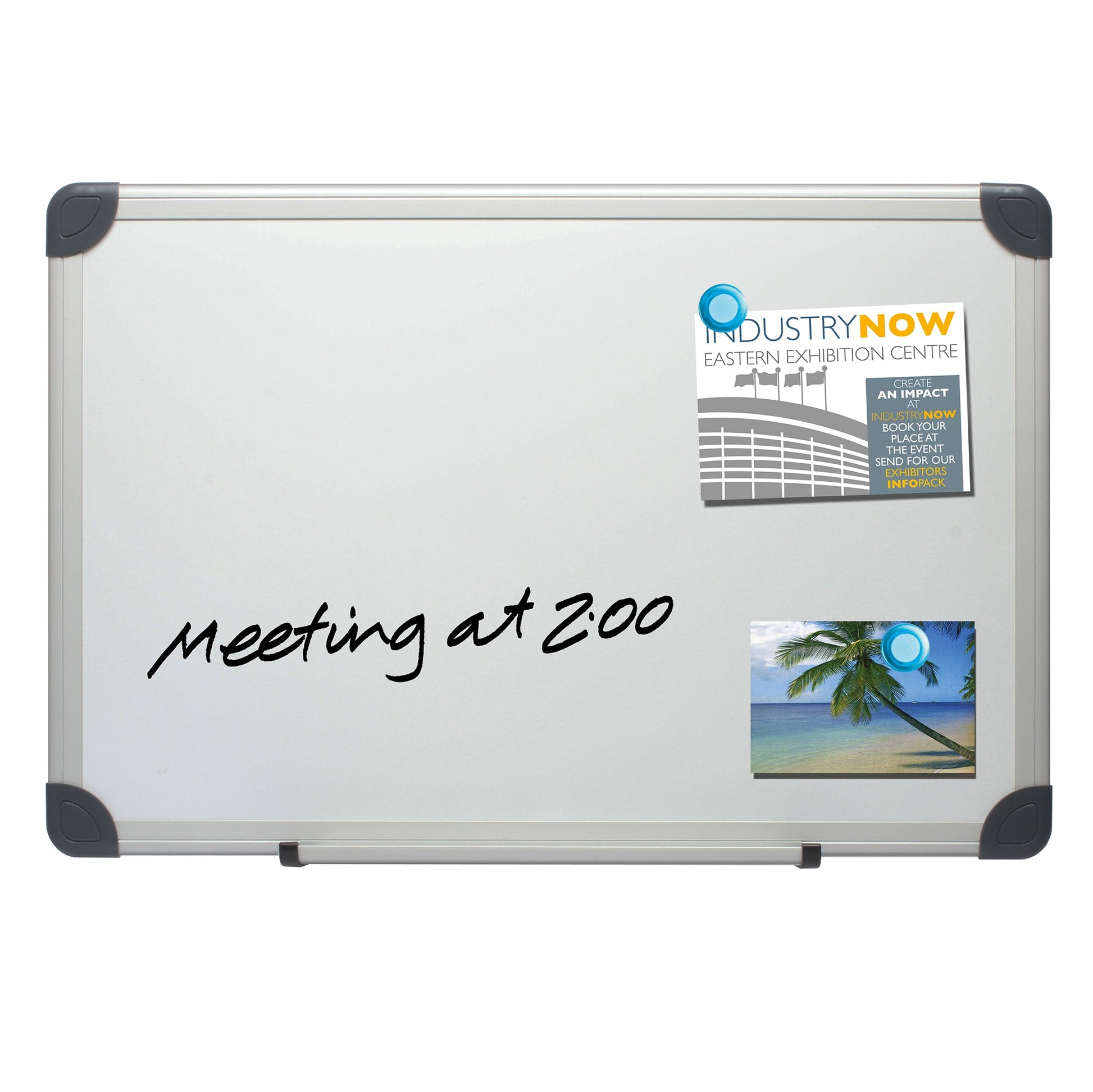 The image displays a magnetic whiteboard framed with an aluminium edge and grey corner protectors. A handwritten note reads "meeting at 2:00," and affixed to the board is a promotional flyer, as well as a postcard, highlighting the versatile uses of the whiteboard. The whiteboard also features a pen tray, suitable for holding markers and erasers.
