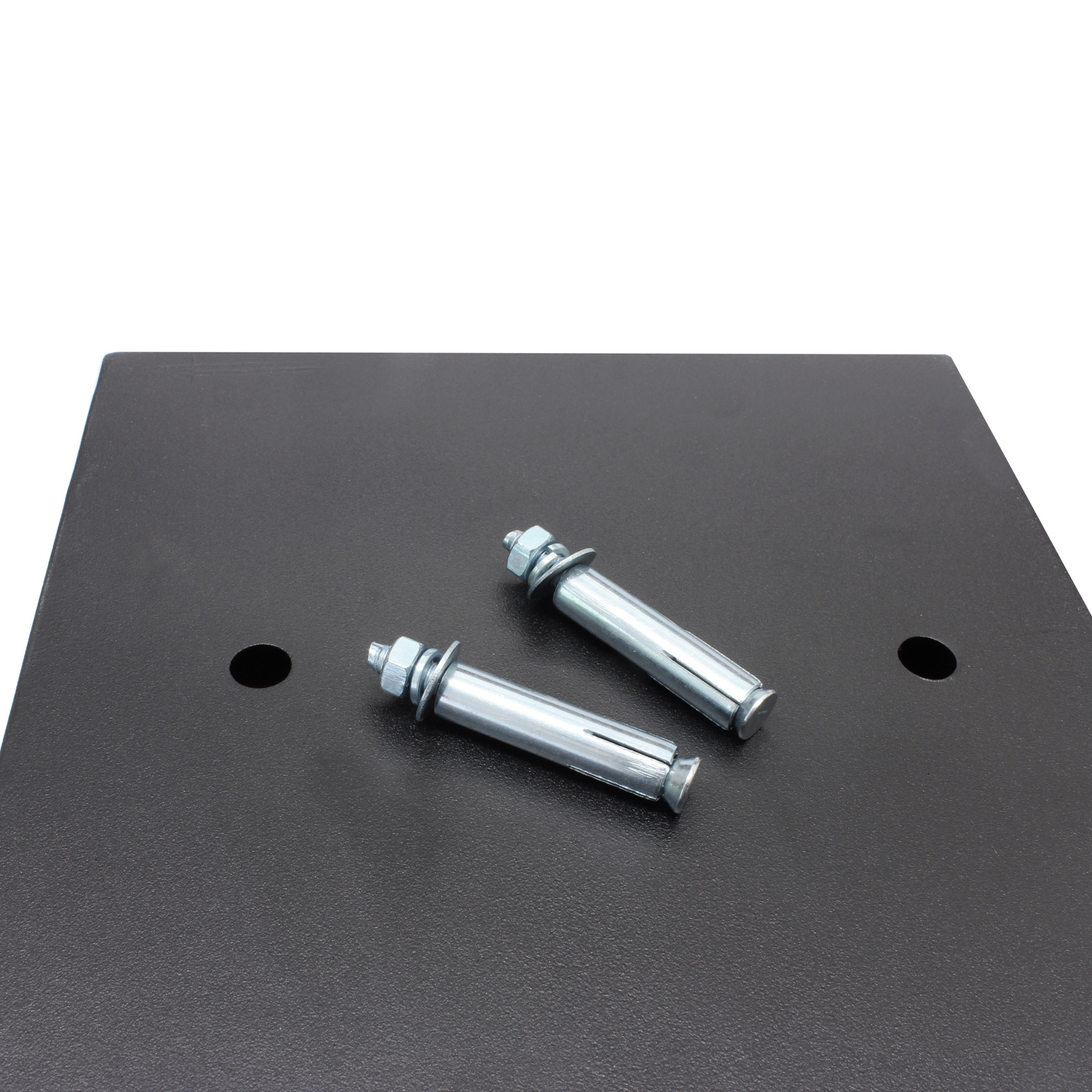 Two metal bolts rest on the black surface of the surface of the Cathedral Products EA15 5 Litre Electronic Digital Safe, next to pre-drilled mounting holes for secure installation.